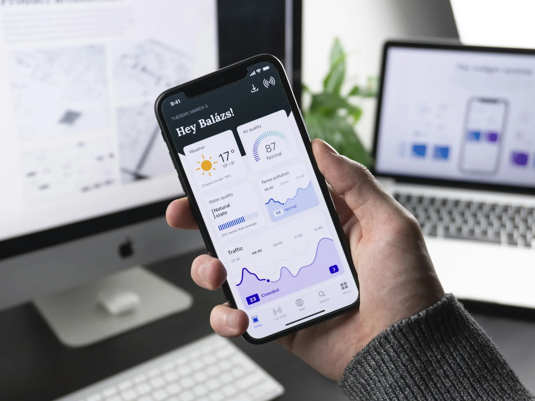 iPhone in hand showing mobile app interface — mobile product development.